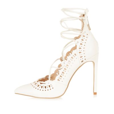 White laser cut lace-up heels